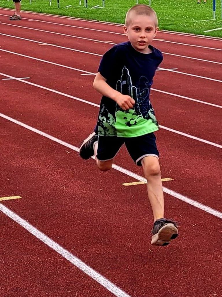 Child running on an outdoor track
