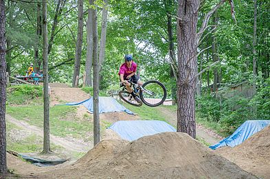 cyclist jumping their bike at the bike park