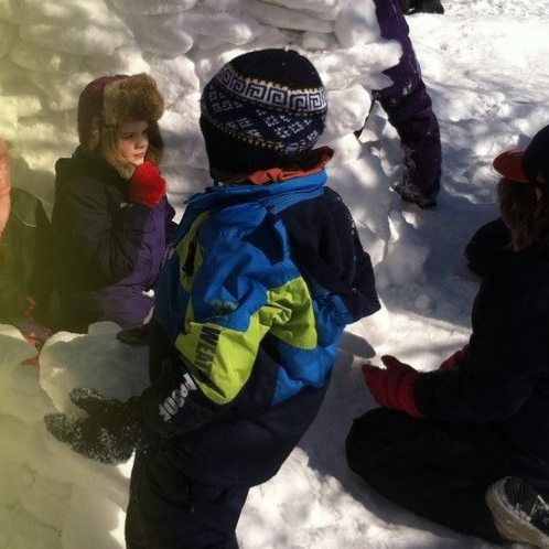 Children making a snow fort wall