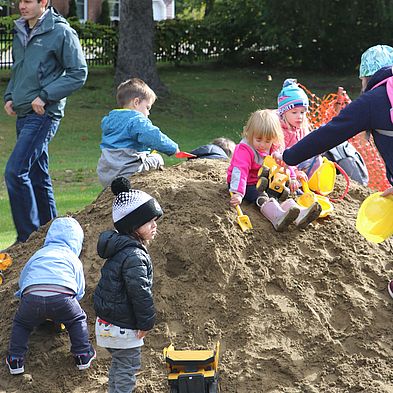 kids digging in sand pile