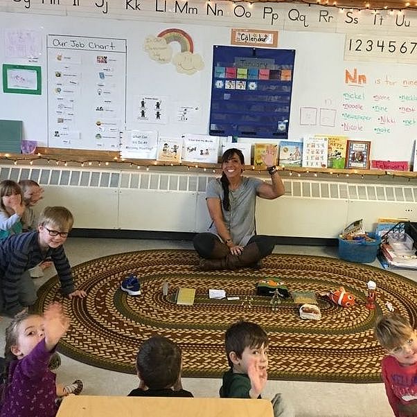 Christina McLaughlin sitting in circle with students