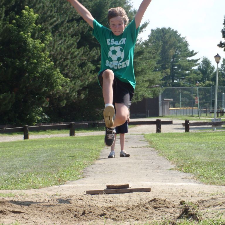 Child doing a track & field long jump