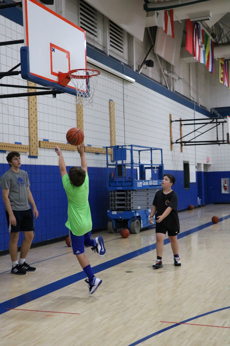 Children playing basketball in a gym