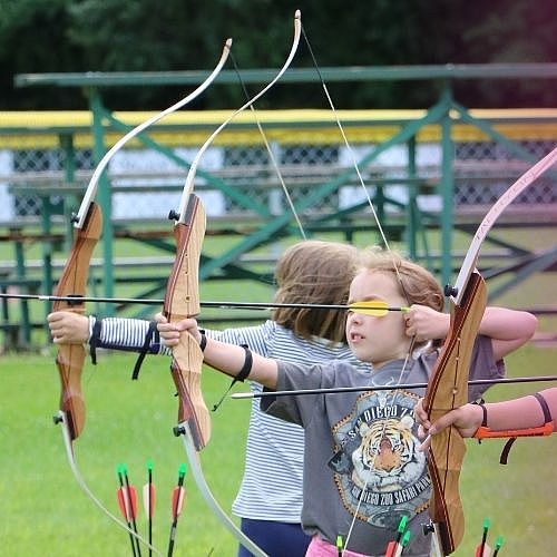 children practicing archery